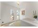 Bright laundry room featuring tile floors, utility sink, two windows, and sun drenched floors at 790 Denards Se Ml, Marietta, GA 30067
