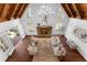A spacious living room with hardwood floors, a stone fireplace, bright windows, and beamed ceilings at 790 Denards Se Ml, Marietta, GA 30067