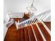 Entry foyer with grand staircase, hardwood floors, and decorative lighting fixture at 790 Denards Se Ml, Marietta, GA 30067