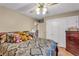Comfortable bedroom showcasing a ceiling fan, wardrobe, and a cozy bed with decorative pillows at 8698 Twin Oaks Dr, Jonesboro, GA 30236