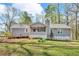 Back exterior featuring a screened-in porch, deck, and well-maintained yard at 8698 Twin Oaks Dr, Jonesboro, GA 30236