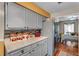 Kitchen with gray cabinets, mosaic tile backsplash, and stainless steel appliances at 8698 Twin Oaks Dr, Jonesboro, GA 30236