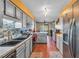 Spacious kitchen with stainless steel appliances, gray cabinets, and wood floors at 8698 Twin Oaks Dr, Jonesboro, GA 30236