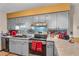 Well-lit kitchen features gray cabinets, stainless steel appliances, and speckled granite countertops at 8698 Twin Oaks Dr, Jonesboro, GA 30236