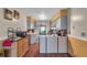 Galley kitchen featuring stainless steel appliances, counter seating, and wood floors at 8698 Twin Oaks Dr, Jonesboro, GA 30236