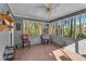 Enclosed sunroom with paneled walls, providing a serene space to enjoy the outdoor view at 8698 Twin Oaks Dr, Jonesboro, GA 30236