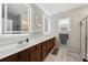 Modern bathroom featuring double sinks, lighted mirrors, and a glass-enclosed shower at 1198 Olmsted Park Rd, Decatur, GA 30033