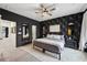 Primary bedroom featuring dark walls, geometric wallpaper, ceiling fan, and ensuite bath at 1198 Olmsted Park Rd, Decatur, GA 30033