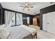 Bedroom featuring dark walls, neutral carpet, and modern ceiling fan at 1198 Olmsted Park Rd, Decatur, GA 30033