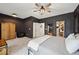 Spacious primary bedroom with dark walls, walk-in closet, and contemporary ceiling fan at 1198 Olmsted Park Rd, Decatur, GA 30033