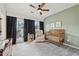 A cozy bedroom featuring a crib, chair, and a large window with dark curtains for ample natural light at 1198 Olmsted Park Rd, Decatur, GA 30033