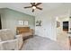 A cozy bedroom featuring a crib, chair, and a large window for ample natural light at 1198 Olmsted Park Rd, Decatur, GA 30033