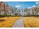 Well-maintained community green space with a paver walkway and mature trees at 1198 Olmsted Park Rd, Decatur, GA 30033