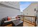 Relaxing deck features a cozy seating area with comfortable couch, table, and charming string lights overhead at 1198 Olmsted Park Rd, Decatur, GA 30033