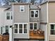 View of deck attached to townhome featuring wood railing, outdoor furniture, and cozy string lights overhead at 1198 Olmsted Park Rd, Decatur, GA 30033