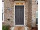 Close-up of a classic six-panel front door with brick facade and house number at 1198 Olmsted Park Rd, Decatur, GA 30033