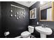 Chic powder room with a pedestal sink, toilet, and unique wall decor at 1198 Olmsted Park Rd, Decatur, GA 30033