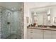 Modern bathroom featuring glass enclosed shower with decorative tiling and a vanity with large mirror at 2820 Andrews Nw Dr, Atlanta, GA 30305