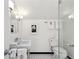 Bright bathroom with black and white floors featuring a toilet, vanity with sink, and glass shower at 2820 Andrews Nw Dr, Atlanta, GA 30305