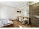 Bathroom featuring marble flooring, a soaking tub, glass enclosed shower, and vanity with sink, toilet, and ample counter space at 2820 Andrews Nw Dr, Atlanta, GA 30305