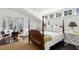 Comfortable bedroom with four-poster bed and sitting area by a bright bay window at 2820 Andrews Nw Dr, Atlanta, GA 30305