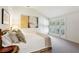 Bright bedroom with a sloped ceiling, neutral decor, shuttered windows, and a comfortable bed with decorative pillows at 2820 Andrews Nw Dr, Atlanta, GA 30305