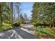 Long private driveway leads to a beautiful home nestled among mature trees and lush landscaping at 2820 Andrews Nw Dr, Atlanta, GA 30305