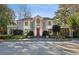 Stately two-story home with a red front door, beautiful bay windows and manicured landscaping at 2820 Andrews Nw Dr, Atlanta, GA 30305