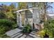Charming exterior view of guest house surrounded by lush greenery and flagstone walkway at 2820 Andrews Nw Dr, Atlanta, GA 30305