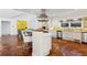 Spacious kitchen with white cabinets, stainless steel appliances, and a unique tile backsplash, accented by terra cotta floors at 2820 Andrews Nw Dr, Atlanta, GA 30305