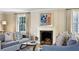 Living room with fireplace, neutral furniture, and natural light from the large window at 2820 Andrews Nw Dr, Atlanta, GA 30305