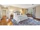 Inviting primary bedroom suite with a king bed, hardwood floors, bay window, and sitting area, plus a colorful area rug at 2820 Andrews Nw Dr, Atlanta, GA 30305