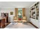 Home office with built-in bookshelves, wood desk, comfortable chairs, and natural light at 2820 Andrews Nw Dr, Atlanta, GA 30305