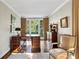 Home office with a wood desk, matching shelving, natural light and a comfortable chair at 2820 Andrews Nw Dr, Atlanta, GA 30305