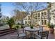 Back patio with brick pavers and an outdoor seating area featuring a round table and chairs, great for entertaining at 2820 Andrews Nw Dr, Atlanta, GA 30305