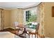 Sitting room with a round wood table, chairs, and an abundance of natural light from the large window at 2820 Andrews Nw Dr, Atlanta, GA 30305