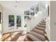 Staircase with large windows, tile landing and access to the backyard at 2820 Andrews Nw Dr, Atlanta, GA 30305