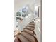 Carpeted staircase with large windows offering abundant natural light at 2820 Andrews Nw Dr, Atlanta, GA 30305