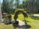 A stone walkway with a foliage-covered arch leads to a spacious backyard with mature trees at 3076 Harris Mill Ct, Duluth, GA 30096