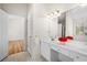 Bright bathroom featuring double sinks, white cabinets, and natural light at 3076 Harris Mill Ct, Duluth, GA 30096