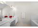 Clean bathroom boasts double sinks, white cabinets, and ample counter space at 3076 Harris Mill Ct, Duluth, GA 30096