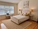 Bright bedroom with a large window, elegant bed, and neutral decor at 3076 Harris Mill Ct, Duluth, GA 30096