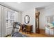 Bright bedroom featuring a treadmill, desk with mirror, and hardwood flooring at 3076 Harris Mill Ct, Duluth, GA 30096