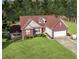 Well-maintained home featuring red brick accents and a lush green lawn at 3076 Harris Mill Ct, Duluth, GA 30096
