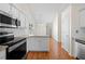 Bright kitchen with stainless steel appliances, granite countertops, and hardwood floors at 3076 Harris Mill Ct, Duluth, GA 30096