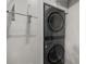 Modern laundry room with sleek, stacked washer and dryer maximizing space and efficiency at 3076 Harris Mill Ct, Duluth, GA 30096