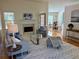 Open living room with fireplace, hardwood floors, and access to dining area at 3076 Harris Mill Ct, Duluth, GA 30096