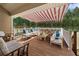 Outdoor patio area featuring comfortable seating, an awning for shade, and a relaxing atmosphere at 3076 Harris Mill Ct, Duluth, GA 30096