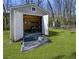 An open shed with shelving, storage, and a ramp for easy access at 3076 Harris Mill Ct, Duluth, GA 30096