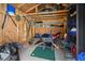 Inside a wooden storage shed, tools, shelving, and a wheelbarrow provide space for organized storage at 3076 Harris Mill Ct, Duluth, GA 30096